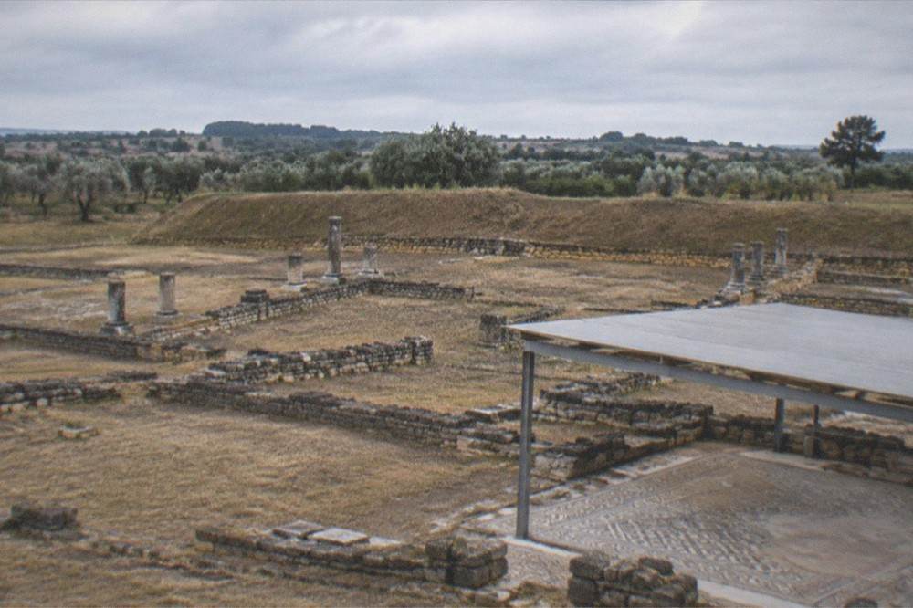 The excavated Roman ruins of Conimbriga with column bases and mosaic floors under open sky
