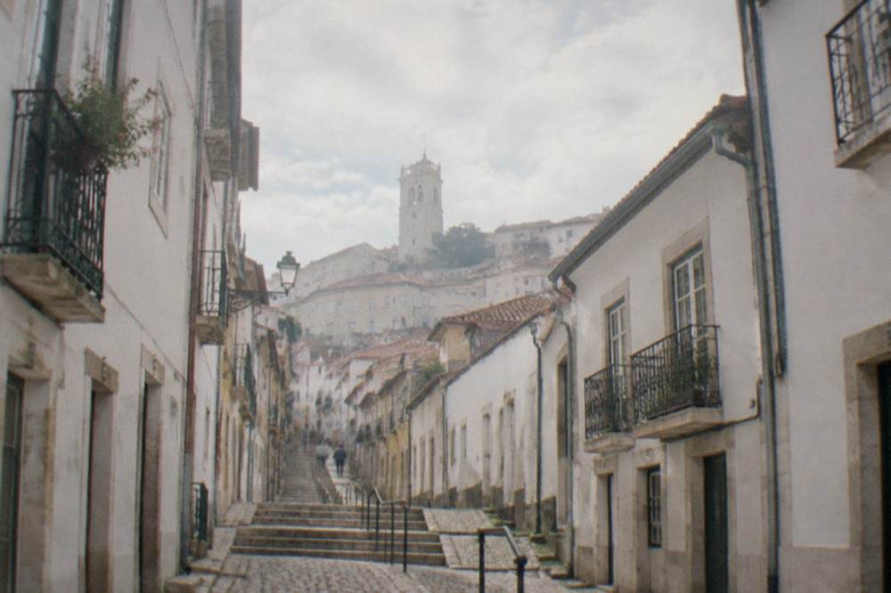 Cobbled lane in Coimbra's upper town with old buildings on both sides