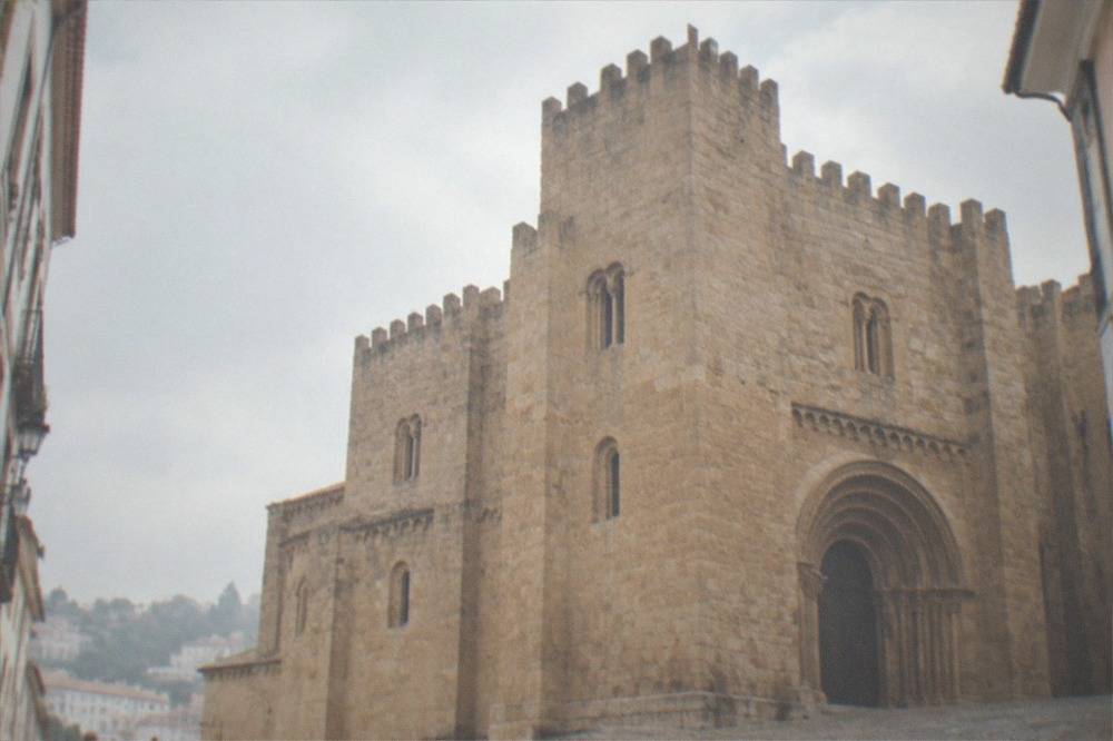 Romanesque exterior of the Sé Velha old cathedral in Coimbra with solid stone walls