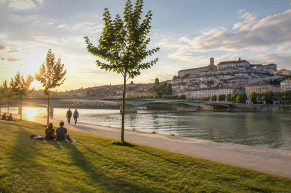 The River Mondego at golden hour with the old city of Coimbra rising on the far bank