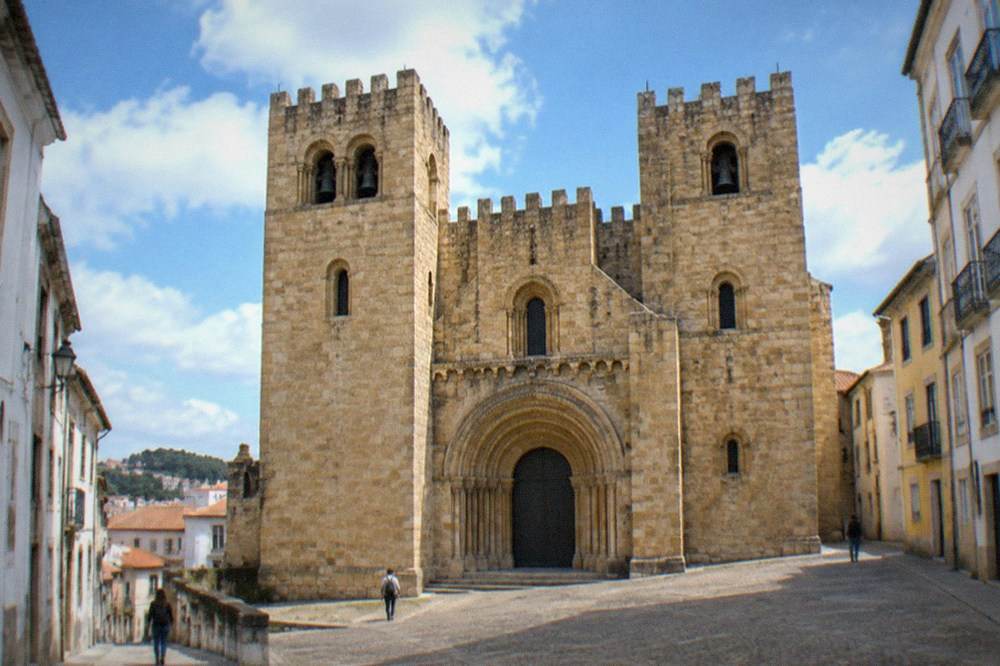 The Romanesque doorway and twin towers of the Sé Velha, the old cathedral of Coimbra